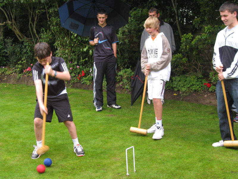 Playing croquet, undeterred by the rain