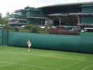 Dwarfed by the showcourt in the background, Amy Ellis is unfazed at the Road To Wimbledon.